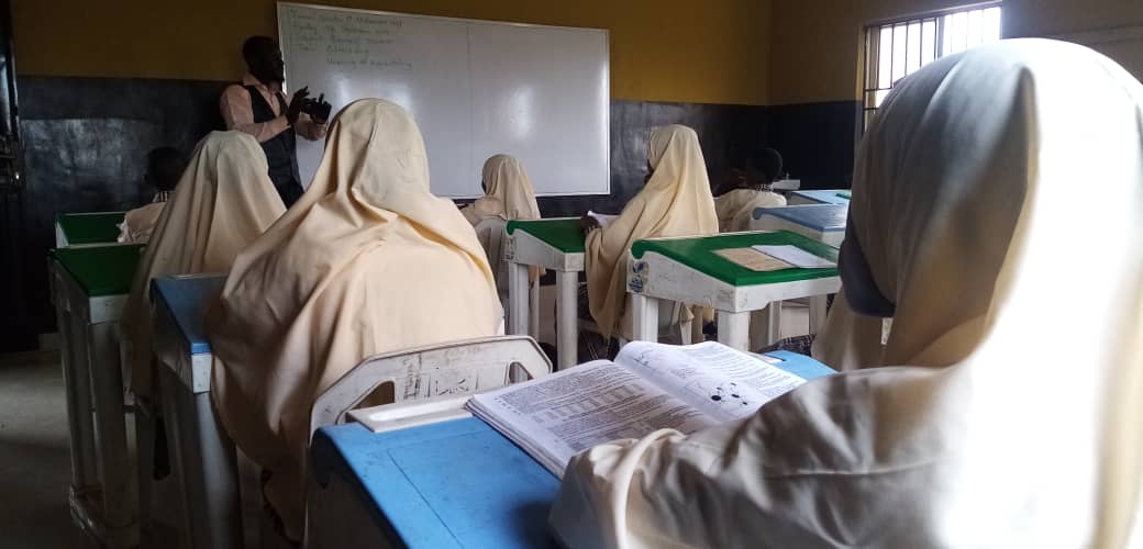 Students learning in classroom with teacher